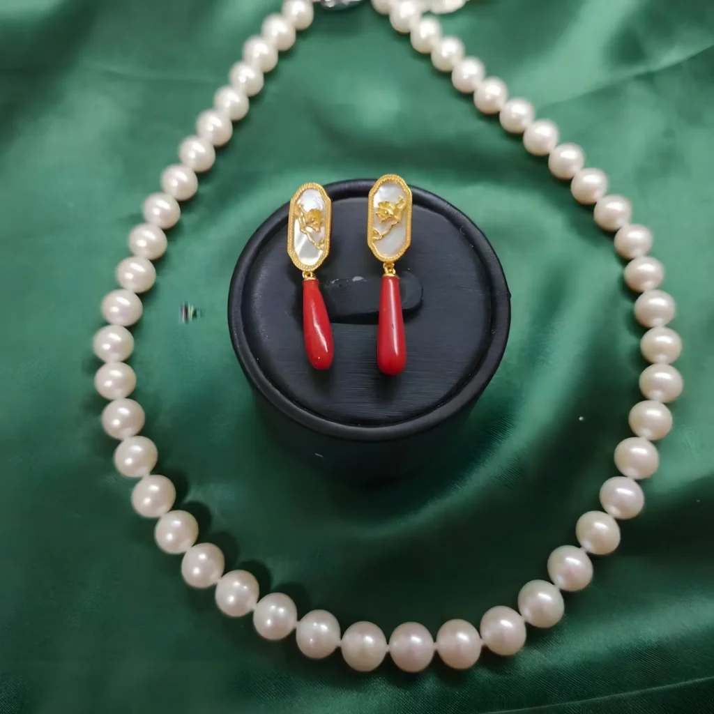 pearl necklace and red coral earrings